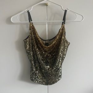 Shiny hambre gold Free People tank top in size XS.